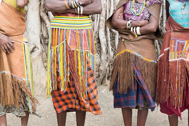 four people wearing fringed clothes