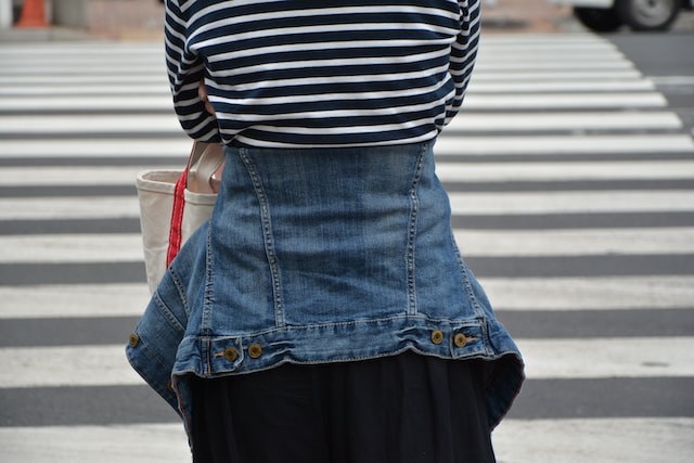 woman in blue denim skirt and black and white striped shirt